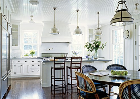 White kitchen with eat in dining space and bistro chairs